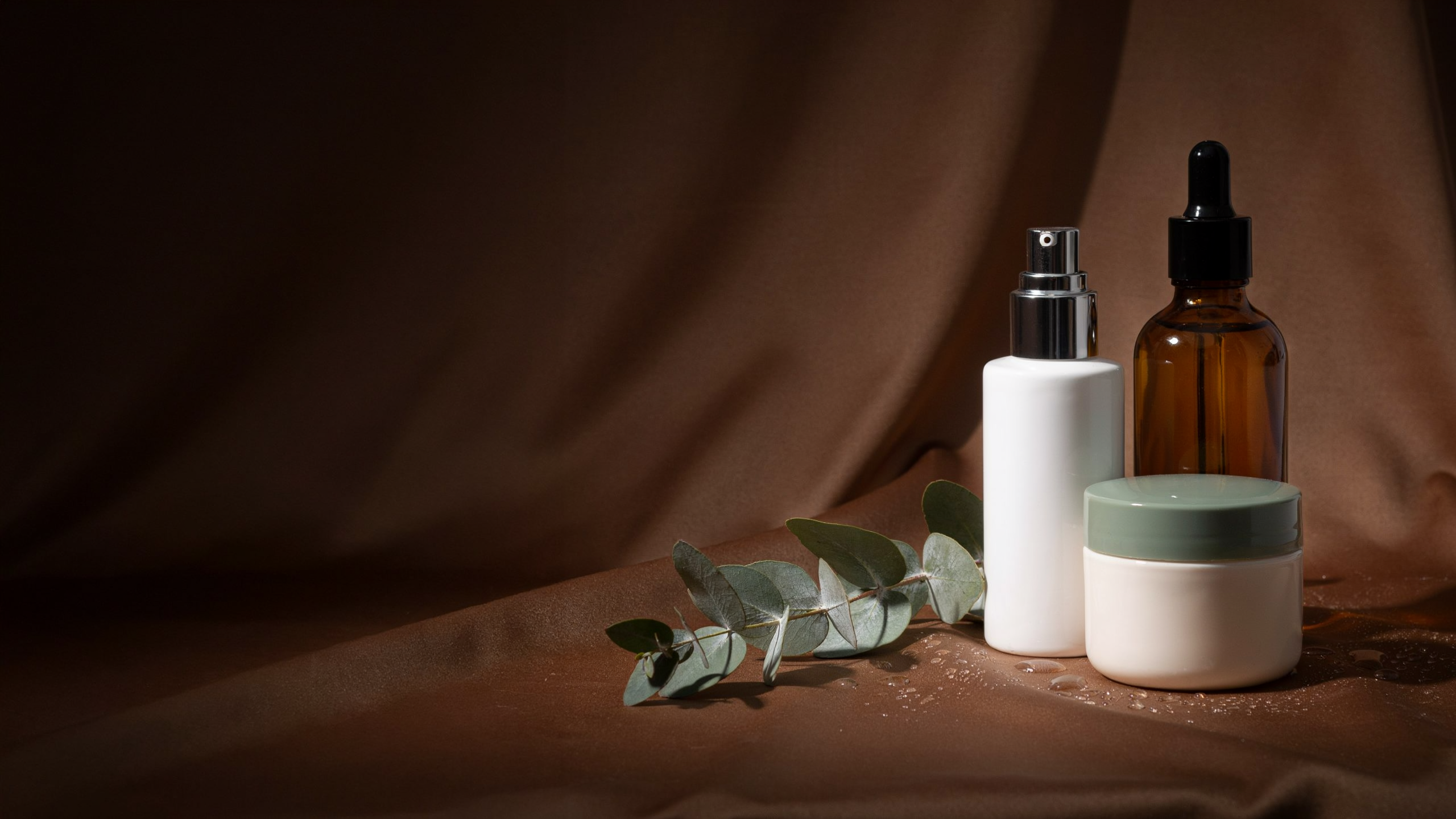 Korean skincare products arranged on warm silk with golden light